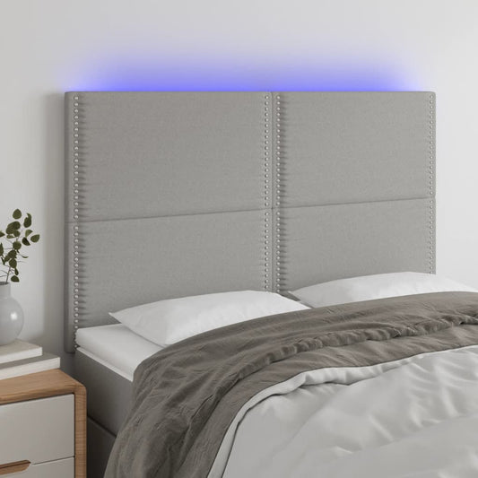 Sänggavel LED ljusgrå 144x5x118/128 cm tyg