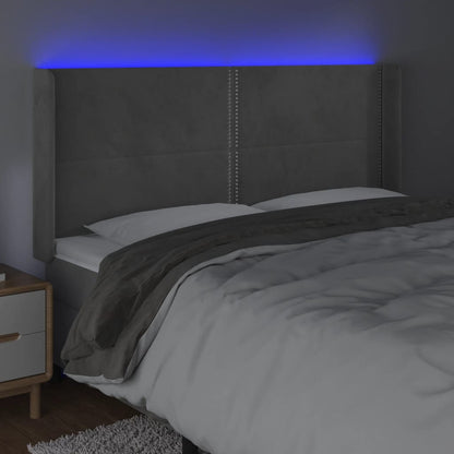 Sänggavel LED ljusgrå 183x16x118/128 cm sammet